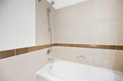 a bathroom with a bath tub and a shower at Luxury 1BR, Long Stays & Walk to Burj Khalifa, High Speed Internet in Dubai