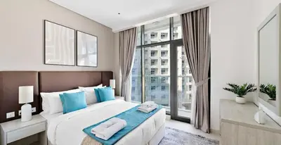 a bedroom with a large bed with towels on it at Beach Access, Skyline Views, 2 Bedroom and Hall in Dubai