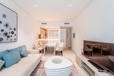 a living room with a white couch and a table at Beach Access, Skyline Views, 2 Bedroom and Hall in Dubai