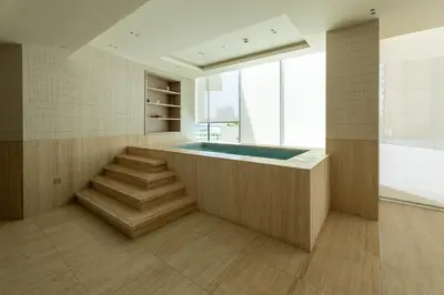 a bathroom with a hot tub and stairs in a room at Stylish 1BR Residence in Binghatti Royale with Balcony in Dubai
