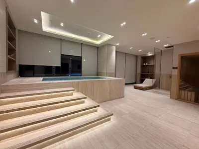 a lobby with stairs and a swimming pool at Stylish 1BR Residence in Binghatti Royale with Balcony in Dubai