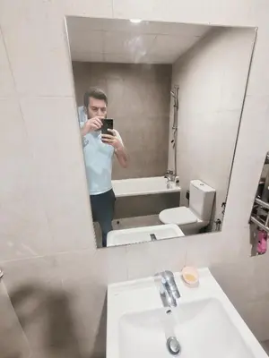 a man taking a picture of himself in a bathroom mirror at 2 Bedroom Furnished Apartment in Dubai