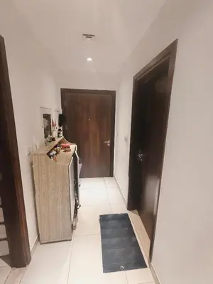 a room with a hallway with a door and a rug at 2 Bedroom Furnished Apartment in Dubai