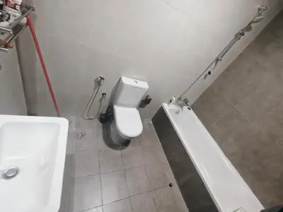 a bathroom with a white toilet and a sink at 2 Bedroom Furnished Apartment in Dubai