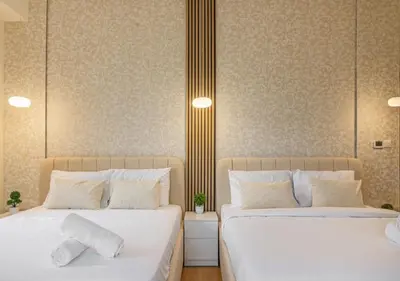 two beds sitting next to each other in a bedroom at 2BR Beach Side Lux JBR Retreat - Luxury Pool Bahar in Dubai