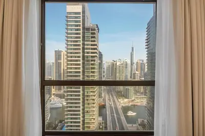 a view of a city skyline from a window at 2BR Beach Side Lux JBR Retreat - Luxury Pool Bahar in Dubai