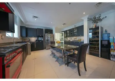 a large kitchen with a table and chairs in it at Signature Palm Villa Ultra-Luxury 5 BDR Retreat in Dubai