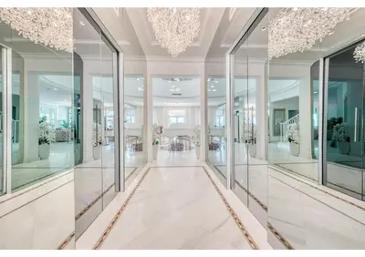 a lobby with glass windows and a staircase at Signature Palm Villa Ultra-Luxury 5 BDR Retreat in Dubai