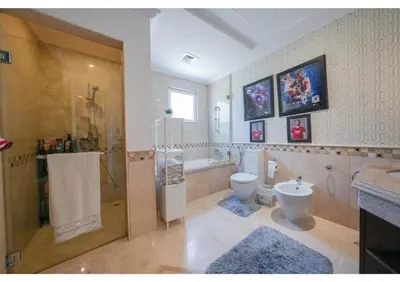 a bathroom with a shower and a toilet and a sink at Signature Palm Villa Ultra-Luxury 5 BDR Retreat in Dubai