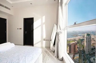 a bedroom with a white bed and a large window at 2BR Near to Beach JBR Dubai Eye & Sea View SV 2805 in Dubai