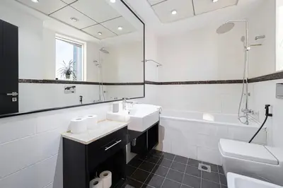 a white bathroom with a sink and a tub at 2BR Near to Beach JBR Dubai Eye & Sea View SV 2805 in Dubai