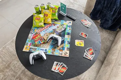 a table with food and toys on top of it at Family 4BR Villa | PS5 & Garden | New Community in Dubai