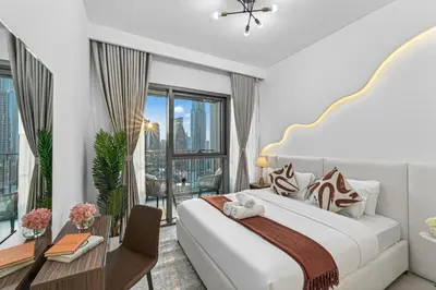 a bedroom with a large bed and a balcony at 2BR Burj View - Downtown Views 2 - Dubai Mall Access in Dubai