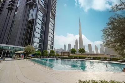 a large swimming pool in a city with tall buildings at 1BR VIDA Dubai Mall - LUXURY DOWNTOWN DUBAI STAY - NAMUVE in Dubai