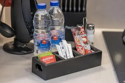 a box with two bottles of water on a desk at 1BR VIDA Dubai Mall - LUXURY DOWNTOWN DUBAI STAY - NAMUVE in Dubai