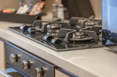 a stove top oven with a black burner on a counter at 1BR VIDA Dubai Mall - LUXURY DOWNTOWN DUBAI STAY - NAMUVE in Dubai