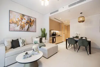 a living room with a couch and a table at 1BR VIDA Dubai Mall - LUXURY DOWNTOWN DUBAI STAY - NAMUVE in Dubai