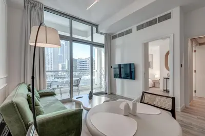 a living room with a couch and a table at Urban Chic 1Bedroom in DEC Tower Marina in Dubai
