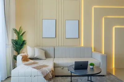 a living room with a couch and a laptop on a table at Luxury 3 BR in Dubai Marina By dPie DEC 2003 in Dubai