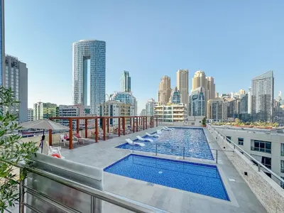 a swimming pool on top of a building with a city skyline at Luxury 3 BR in Dubai Marina By dPie DEC 2003 in Dubai