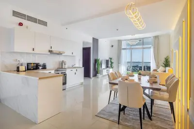a kitchen and dining room with a table and chairs at Luxury 3 BR in Dubai Marina By dPie DEC 2003 in Dubai