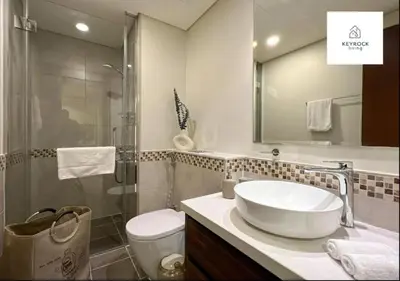 a bathroom with a sink and a shower and a toilet at Modern 1-Bedroom Luxury Stay with Lake View in Reva, Business Bay in Dubai