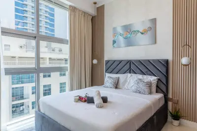 a bedroom with a bed with two stuffed animals on it at Luxury 3 BR w Private Jacuzzi in Marina DEC 2203 in Dubai