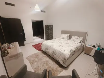 a white bedroom with a bed and a rug at Private Room with Bath in Dubai