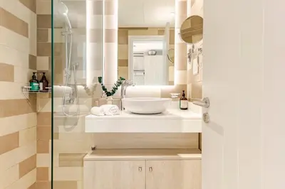 a bathroom with a sink and a glass shower at Studio in Seven Palm in Dubai