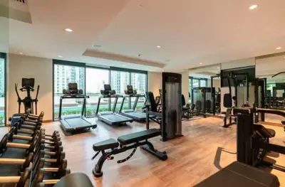 a gym with treadmills and exercise equipment in a building at Burj Khalifa Area- 2 Chic BR, Act Tower Dubai Mall in Dubai