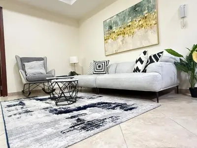 a living room with a couch and a rug at Zenstay-Modern 2BR in JLT-Near Marina& Metro in Dubai