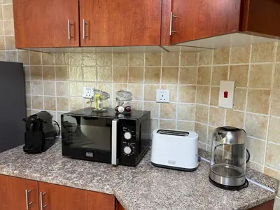a kitchen counter with a microwave and a toaster at Zenstay-Modern 2BR in JLT-Near Marina& Metro in Dubai