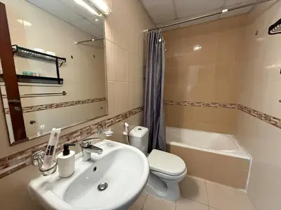 a bathroom with a sink and a toilet and a mirror at Zenstay-Modern 2BR in JLT-Near Marina& Metro in Dubai