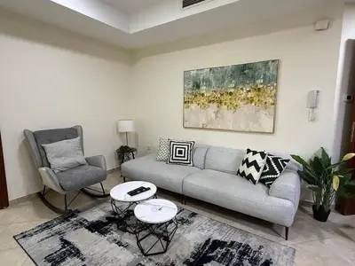 a living room with a couch and two chairs at Zenstay-Modern 2BR in JLT-Near Marina& Metro in Dubai