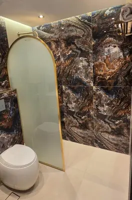 a bathroom with a toilet and a mirror at Luxury Marina View 2BR Apartment for 6 in Dubai