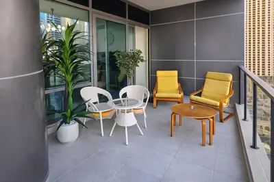 a balcony with chairs and a table and chairs at Luxury Marina View 2BR Apartment for 6 in Dubai