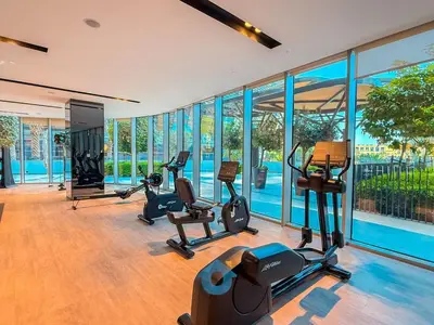 a gym with treadmills and exercise equipment in a building at Wake up To Burj Khalifa Views Luxury 2 BR LikeHome in Dubai