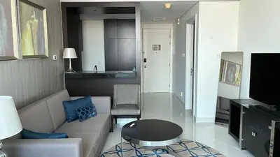 a living room with a couch and a table at Damac Maison The Distinction 1 BHK Burj Khalifa in Dubai