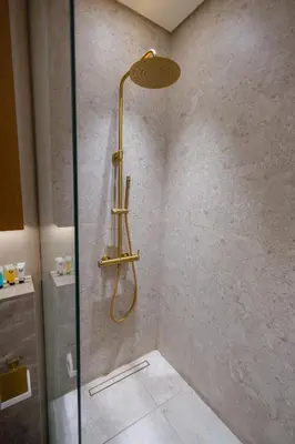 a shower with a shower head in a bathroom at Luxury Studio with Private Jacuzzi at Trillionaire, Business Bay in Dubai