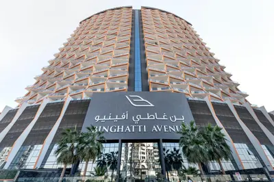 a tall building with a sign in front of it at Modern 1BR with Pool & Gym, Burj Khalifa View, Al Jaddaf in Dubai