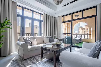 a living room with a couch and a table at Frank Porter - Al Tajer Residences in Dubai