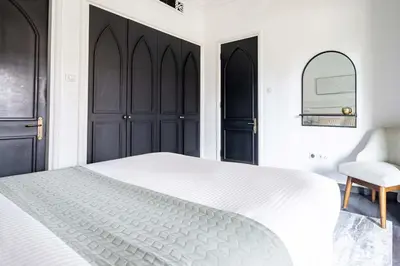 a bedroom with a white bed and a chair at Frank Porter - Al Tajer Residences in Dubai