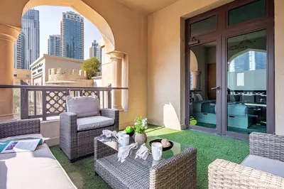 a patio with chairs and a table on a balcony at Frank Porter - Al Tajer Residences in Dubai