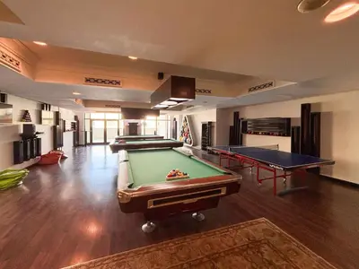 a living room with two pool tables in it at Frank Porter - Al Tajer Residences in Dubai