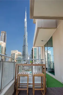 two chairs on a balcony with a view of the city at Frank Porter - Blvd Central in Dubai