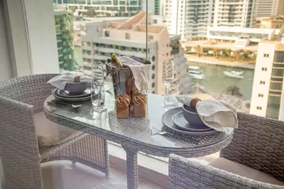 a glass table with plates of food on top of a window at Frank Porter - Studio One Tower in Dubai