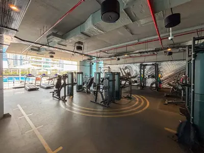 a gym with cardio equipment and a mural on the wall at Frank Porter - Studio One Tower in Dubai