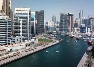 a river in a city with boats in the water at Frank Porter - Studio One Tower in Dubai