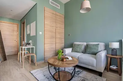 a living room with a couch and a table at Frank Porter - Studio One Tower in Dubai