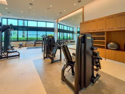 a gym with treadmills and ellipticals in a building at Frank Porter - Address Beach Resort Tower in Dubai